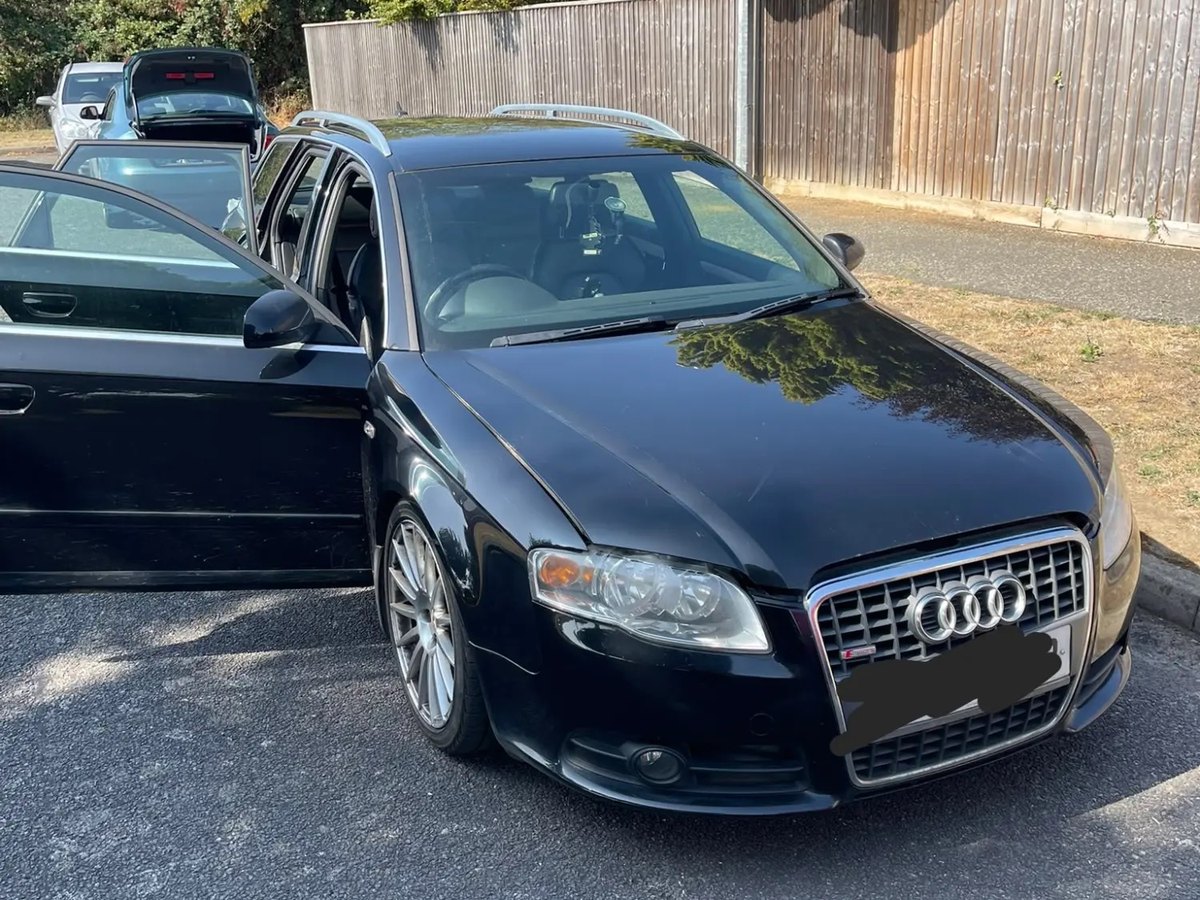 A black Audi estate with its doors open, ready for a service