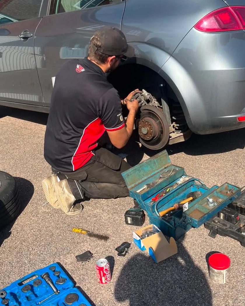 James Snow of SV Autos changing a car's rear brakes on a customer's driveway